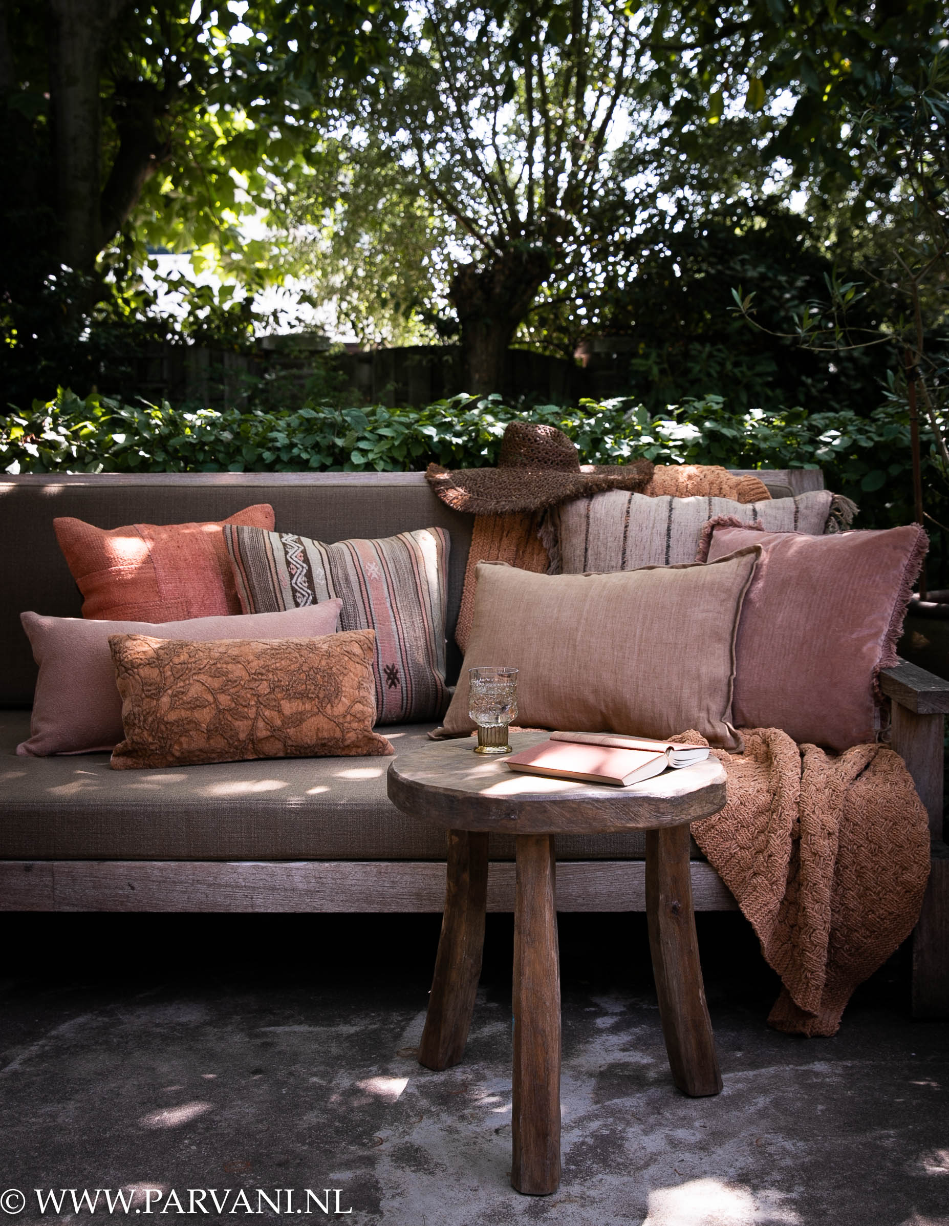 Loungebank met kussens in warme bruin terra oudroze kleuren met kelim, linnen, velvet en grof gehaakt plaid