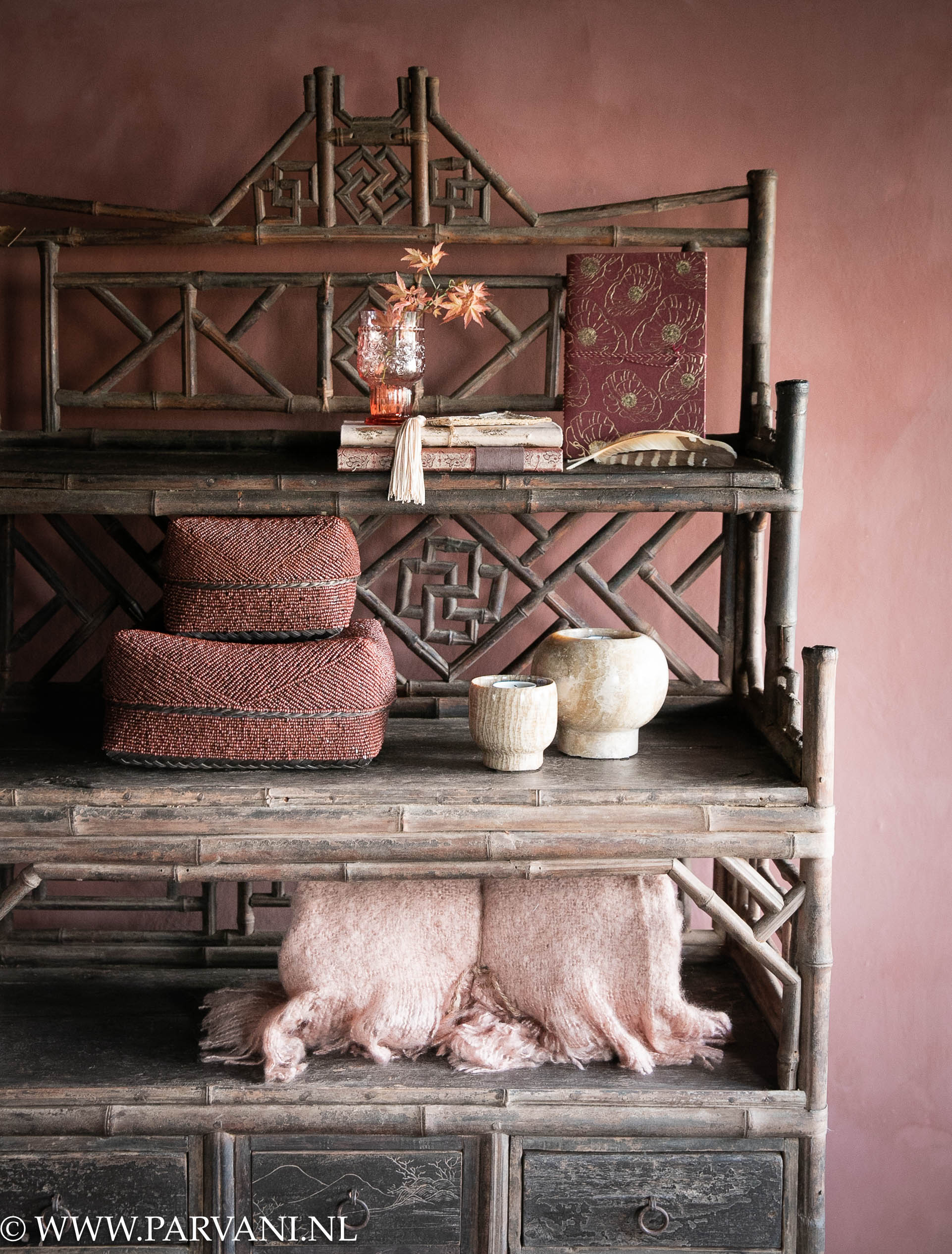 Oud uniek Chinees bamboe houten kast/ wandrek met planken, lades en donkere kleur met oudroze accessoires en kalkverf