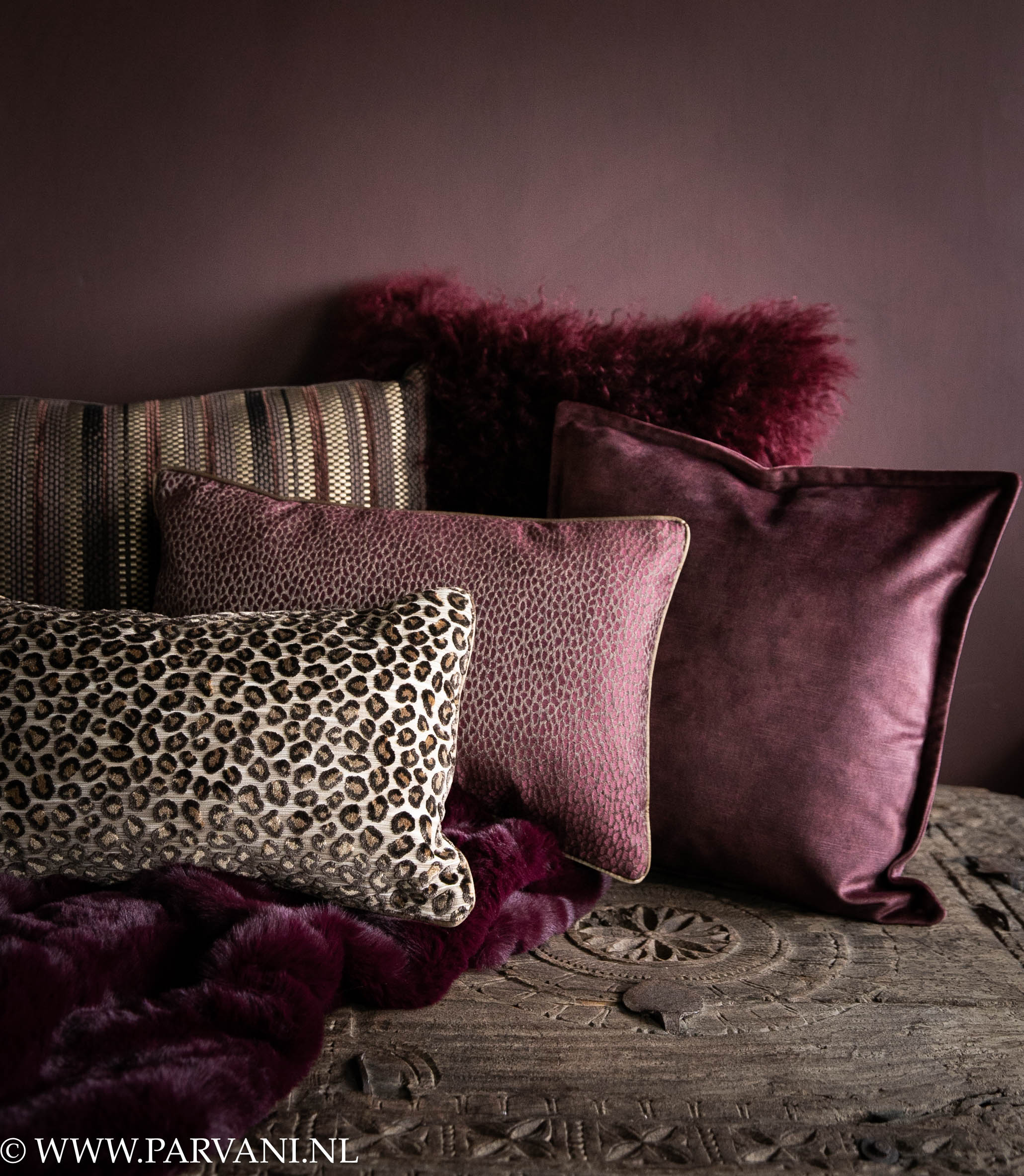 Faux fur bontplaid en kussens in warme aubergine, burgundy, paarse kleuren met luipaard dessin, vacht en velvet